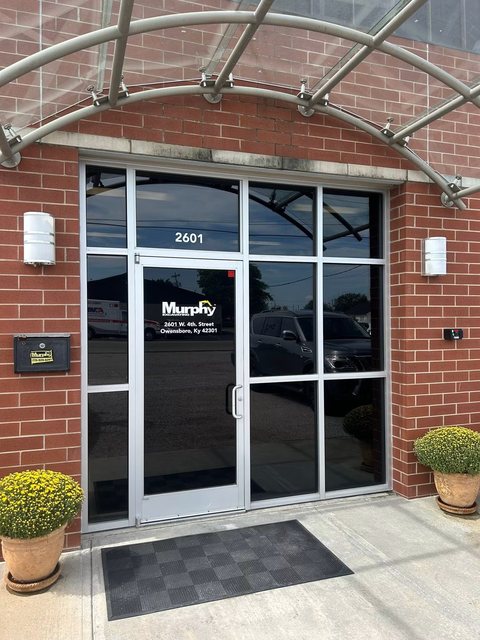 Brick office building entry with tinted glass doors